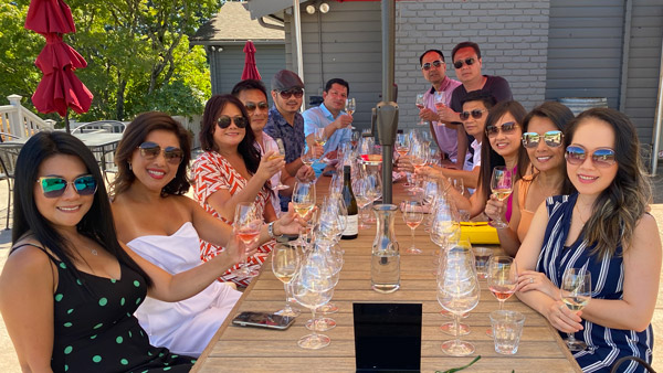 IMG_1646-web photo of a group of 12 people sitting around a table with wine glasses