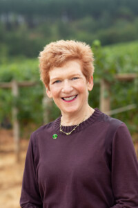 Page Knudsen Cowles Smiling mature woman with short red hair.